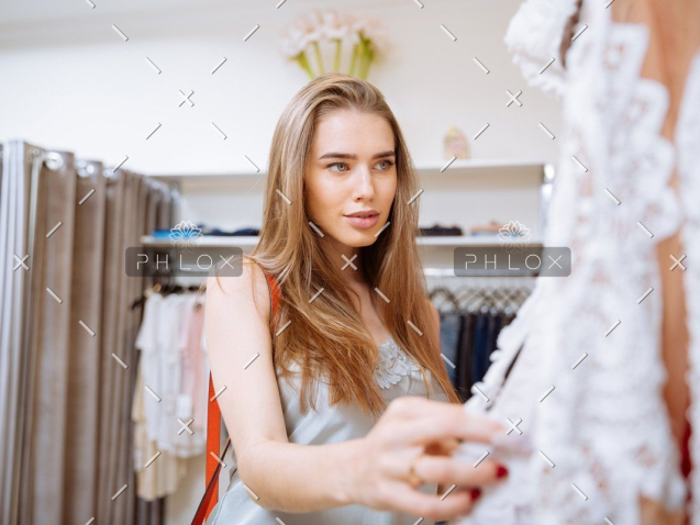 Home 36 demo-attachment-141-woman-doing-shopping-and-choosing-clothes-in-PDEP6XU
